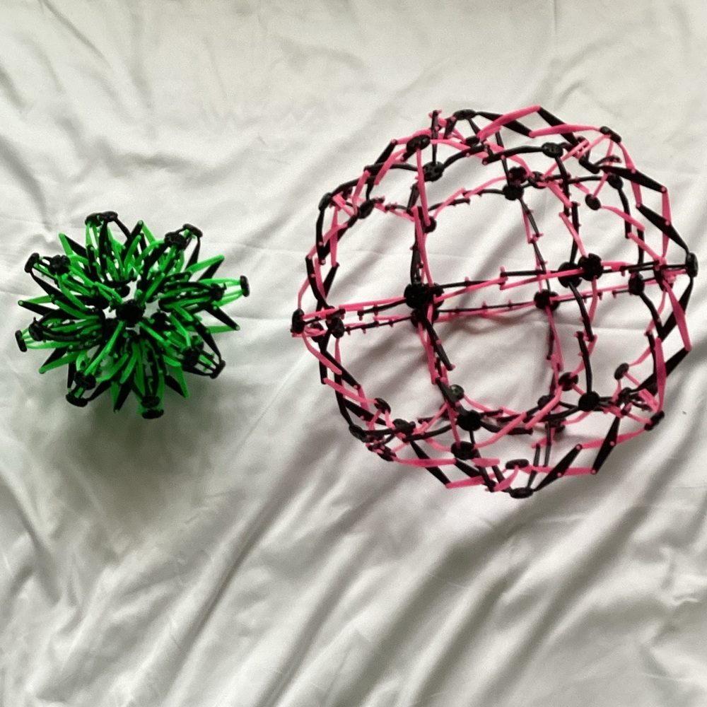 Two Expandable Green and Pink Sphere Toys - Picture 2 of 3